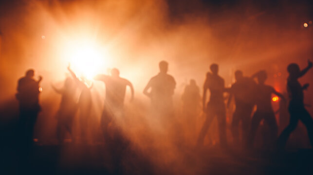 Defocused crowd of people dancing at party in the moshpit