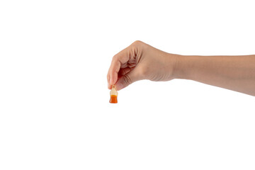 Cola flavored gummy jellies in the shape of cola bottles in hand,isolated on transparent background.