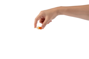 Cola flavored gummy jellies in the shape of cola bottles in hand,isolated on transparent background.