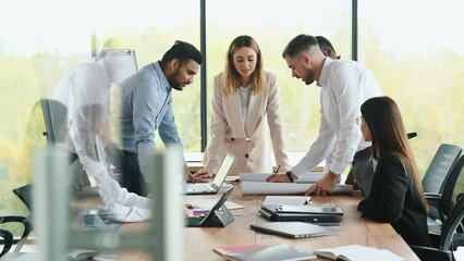 Multiracial partners group of colleagues corporate workers shaking hands greeting gesture agreement in office conference sitting down at table listening report of boss man.