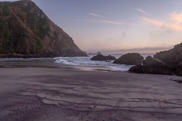 Fototapeta na wymiar Sunset at Pfeiffer Beach, near Big Sur, showing the keyhole rock.