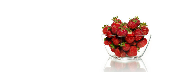 Ripe strawberries in a glass dessert cup on a white background.