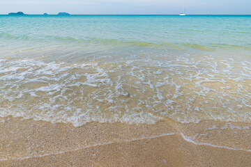 Fototapeta na wymiar Sea beach wave clear turquoise sea water smooth sand blue sky with cloud