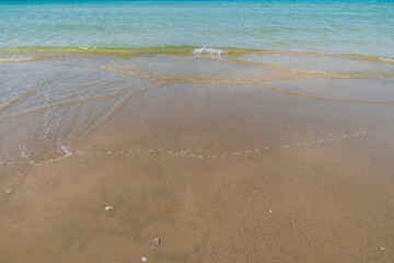 Sea beach wave clear turquoise sea water smooth sand blue sky with cloud