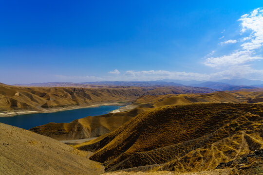 A deserted part of the Zaamin nature reserve in Uzbukistan on a sunny summer day. View of the mountains and reservoir.