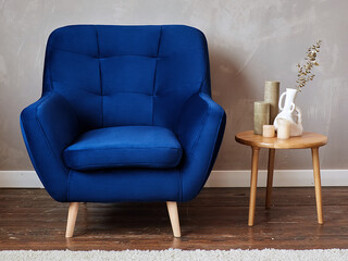 furniture, interior, home design. modern blue fabric armchair with wooden legs, front view