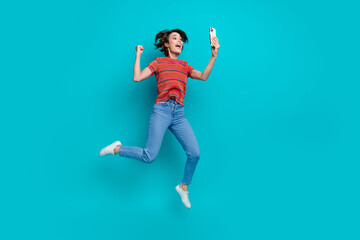 Fototapeta na wymiar Photo of overjoyed crazy cheerful girl wear stylish clothes celebrating success yes hooray isolated on cyan color background