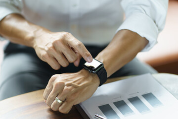 Business man Looking at smart watch In Office online connect Gadget technology