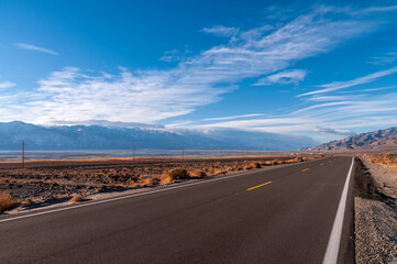 The towering mountains of the Sierra Nevada form a backdrop of the road to Lone Pine, California.