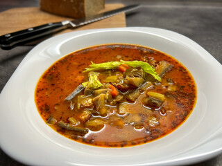 Detail shot of oyster mushroom soup with vegetables and marjoram