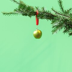 Closeup Green Apple Ornament Christmas decoration hanging on Christmas tree on blue background. 3D Rendering Christmas concept idea.
