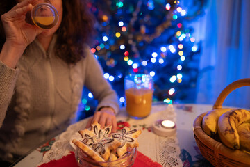 Love-Filled Moments: Curly-Haired Woman Relishes a Heartfelt Snack, Cherishing the Festive...