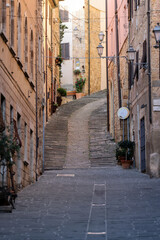 Massa Marittima, Italy - Sept 11, 2022: Steep and narrow street in old town of Massa Marittima, Italy