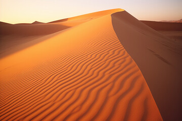 Fototapeta na wymiar Golden hour photograph of sand dunes in the desert, capturing the shifting shadows and warm hues of a desert sunset.