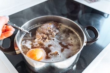 Cook meat broth with vegetables in your home kitchen
