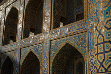 a close-up shot of a colorful geometries in the historical building which reflect sunlight in evening time, Registan square, Samarkand, madrasah.