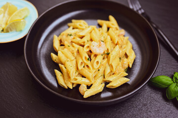  Italian home made   pennette pasta with smoked salmon , creamy sauce and fresh dill on wooden background