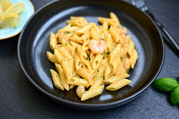  Italian home made   pennette pasta with smoked salmon , creamy sauce and fresh dill on wooden background