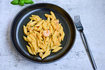  Italian home made   pennette pasta with smoked salmon , creamy sauce and fresh dill on wooden background