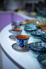 Uzbekistan, traditional tea cups in a display of traditional shop, handicraft items, passing from generation to generation, old crafting.