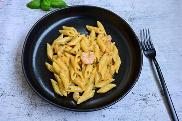  Italian home made   pennette pasta with smoked salmon , creamy sauce and fresh dill on wooden background