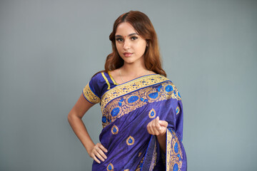 Portrait of young Indian woman in deep purple sari dress