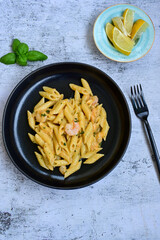  Italian home made   pennette pasta with smoked salmon , creamy sauce and fresh dill on wooden background