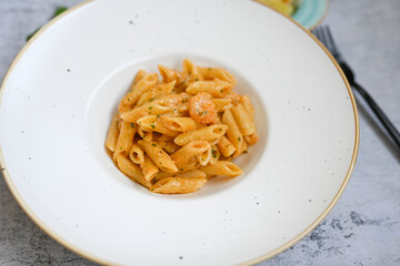  Italian home made   pennette pasta with smoked salmon , creamy sauce and fresh dill on wooden background
