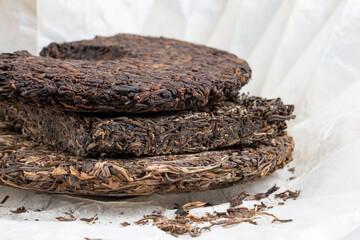 Stack of three different flat disc of puer tea. Pressed Chinese fermented Pu-erh tea.