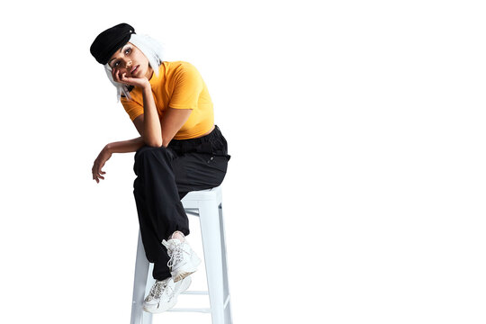 Thinking, urban fashion and woman in chair with idea, relax and isolated on transparent png background. Brainstorming, gen z girl or model sitting on stool with confidence, pride and unique identity.