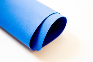 3d rendering blue yoga mat rolled on white background