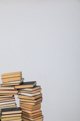 Many stacks of educational books to study in the university library on a background