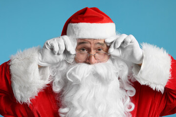 Merry Christmas. Surprised Santa Claus on light blue background