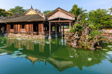 Fototapeta na wymiar the Truong du Pavilion reflected in the lake within the Imperial City of Hue, Vietnam. Imperial Royal Palace of the Nguyen Dynasty in Hue. 