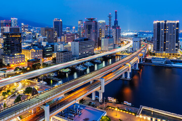 Kobe skyline from above with port and elevated road at twilight in Japan