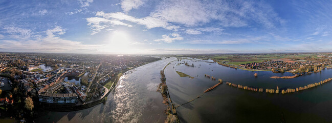 Extreme high water level of river IJssel in Zutphen, The Netherlands, against a clear blue sky....