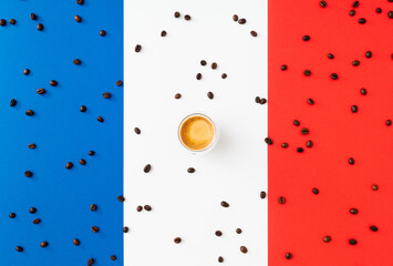Creative layout made of cup of coffee and coffee beans on flag of France as a background. Minimal coffee concept. Trendy espresso idea. Unique flat lay composition. Coffee aesthetic.