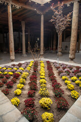 Center of historical place with the tree and lot of colorful flowers, Khiva, the Khoresm...