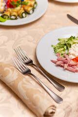 Served festive table with snacks, glasses, glasses, cutlery and napkins for a banquet