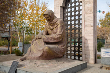 beautiful statue of a old woman outside of a fortress, Khiva, the Khoresm agricultural oasis, Citadel.