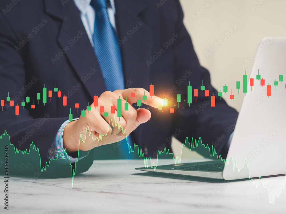 Poster hand of a businessman pointing at graph stock on a virtual screen.