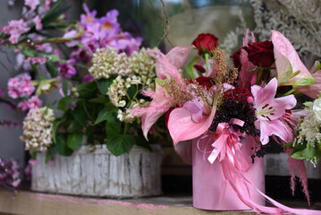 Lots of flowers in flowerpots on the shelf