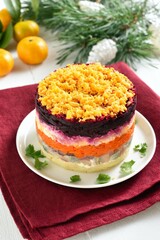Christmas layered vegetable salad with herring and boiled vegetables