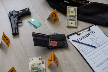 High contrast image of a crime scene with gun and markers on the floor - obrazy, fototapety, plakaty