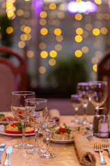 Served festive table with snacks, glasses, glasses, cutlery and napkins for a banquet