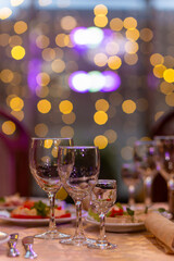 Served festive table with snacks, glasses, glasses, cutlery and napkins for a banquet