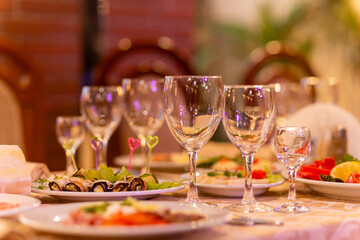 Served festive table with snacks, glasses, glasses, cutlery and napkins for a banquet