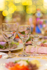 Served festive table with snacks, glasses, glasses, cutlery and napkins for a banquet