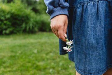 Girl holding flowers in garden