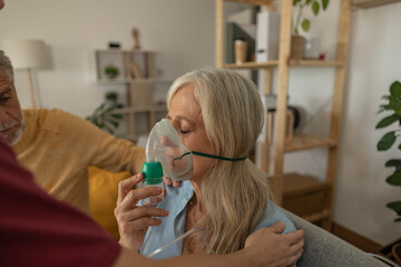 Woman wearing nebulizer at home
